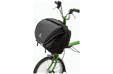 A bike messenger bag securely attached to a Brompton folding bike frame, demonstrating a practical solution for urban cyclists.