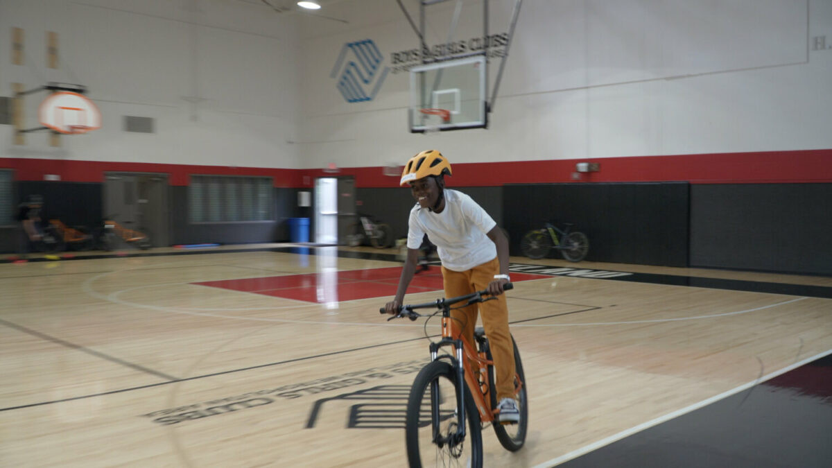 Boys mountain bikers in a gym setting