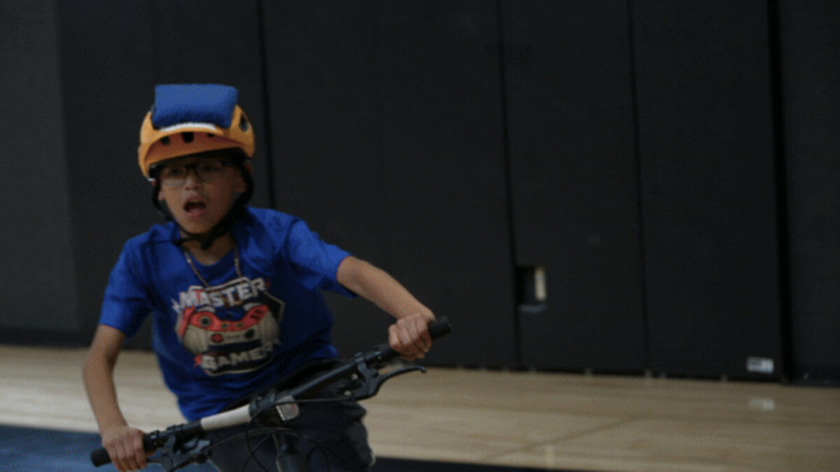 Boys mountain biking skills practice with cones
