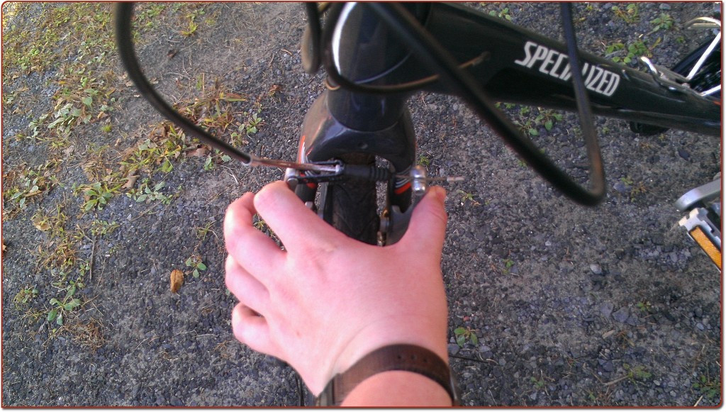 Brake calipers squeezed closed, with brake pads contacting the wheel rim