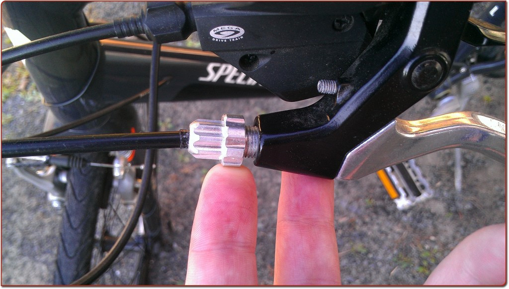 Close-up of the lock nut on the brake lever, unscrewed to loosen it