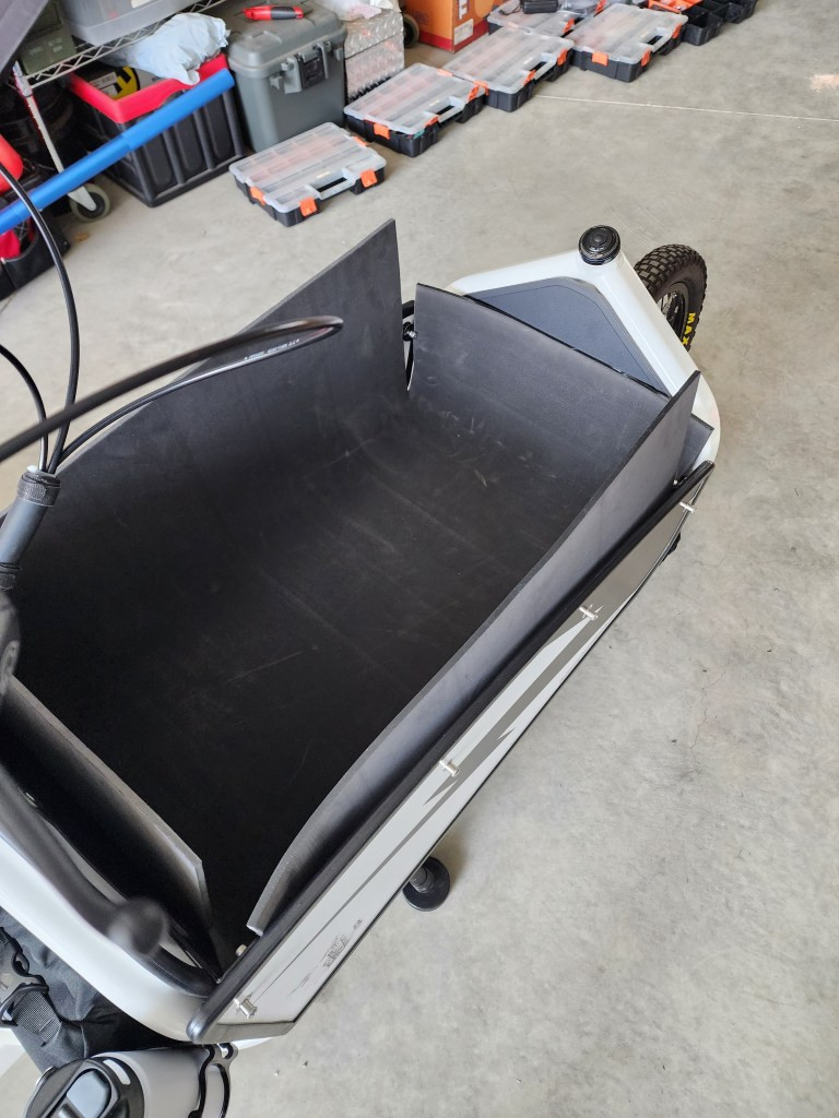 DIY bike rear rack basket padding using a cut-up Therma Rest camping mattress