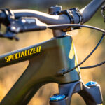 Specialized Stumpjumper frame showcasing internal cable routing for brake hoses only, highlighting the move towards wireless technology in high-end mountain bikes.