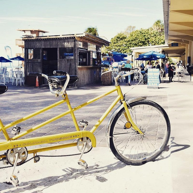 Selection of beach cruisers and other rental equipment outside AMI Beach Fun Rentals, Anna Maria Island