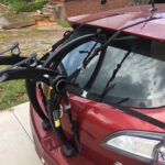Saris Bones 2 bike rack installed on a Mazda 3 hatchback, highlighting the top straps and potential spoiler pressure.