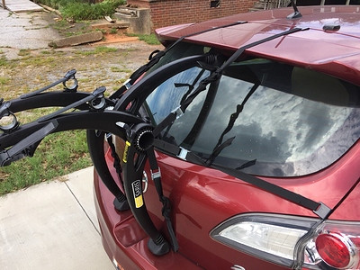 Saris Bones 2 bike rack installed on a Mazda 3 hatchback, highlighting the top straps and potential spoiler pressure.