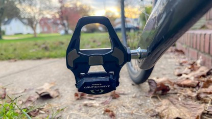 Single-sided road bike pedals with adjustable tension