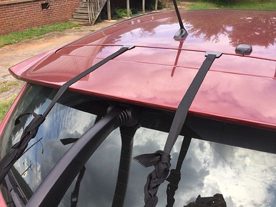 Close-up of Saris Bones 2 hatchback bike rack straps and potential pressure points on the Mazda 3 spoiler.