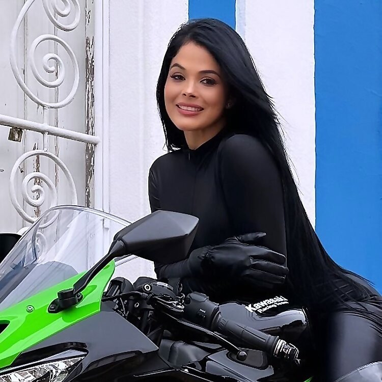 Faby Beltrão posing with motorcycle gear