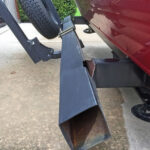 Bike rack attached to a trailer bumper, illustrating a dangerous setup.