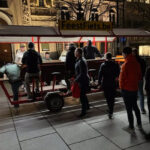 Escape Collective team enjoying a beer bike ride through the streets of Ghent at night.