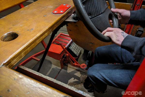 Rustic components of the beer bike, including the pedal and steering mechanism.