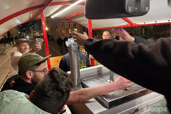A team member expertly pouring beer from the keg on the moving beer bike.