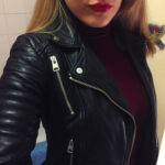 Close-up of the All Saints Papin leather biker jacket, highlighting the textured leather and zipper details.