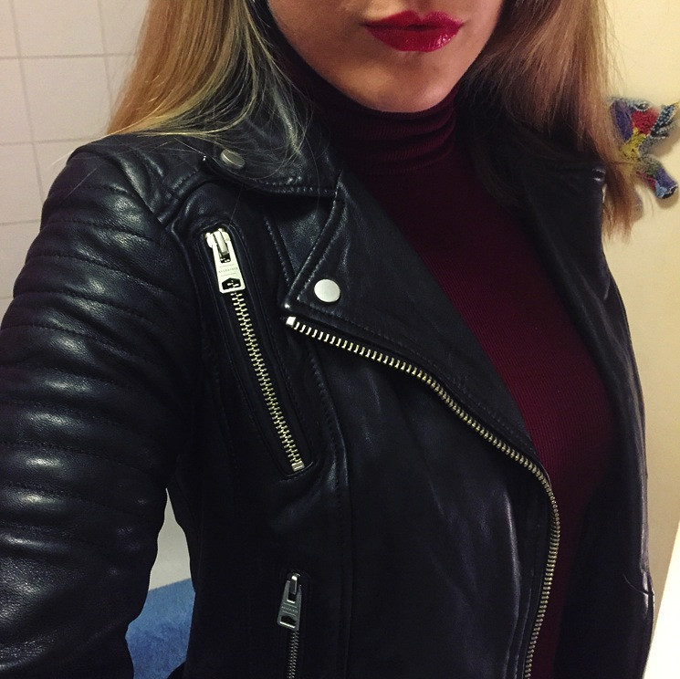 Close-up of the All Saints Papin leather biker jacket, highlighting the textured leather and zipper details.