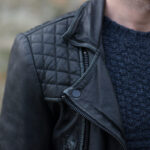 Close-up of the distressed leather and lapel of the AllSaints Cargo biker jacket mens
