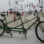 Side view of the Schwinn Twinn Tandem before restoration, showcasing its original condition.