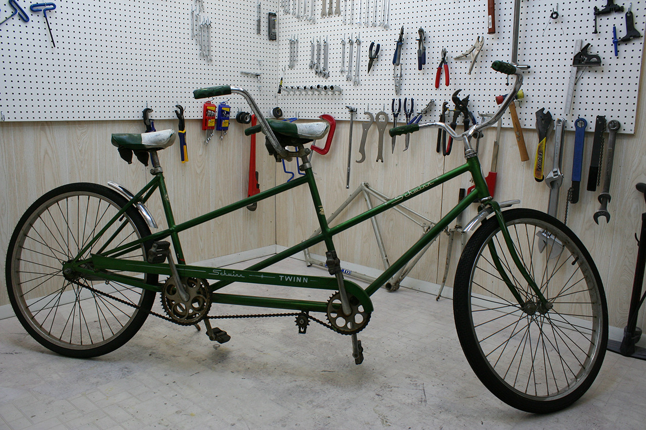Side view of the Schwinn Twinn Tandem before restoration, showcasing its original condition.