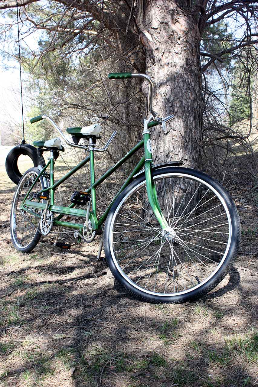Angle view of the restored Schwinn Twinn Tandem, highlighting the gleaming chrome and revived paint.