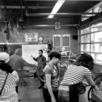 Inside the Bike Kitchen workshop in San Francisco, showcasing a welcoming space for bicycle repair and maintenance.