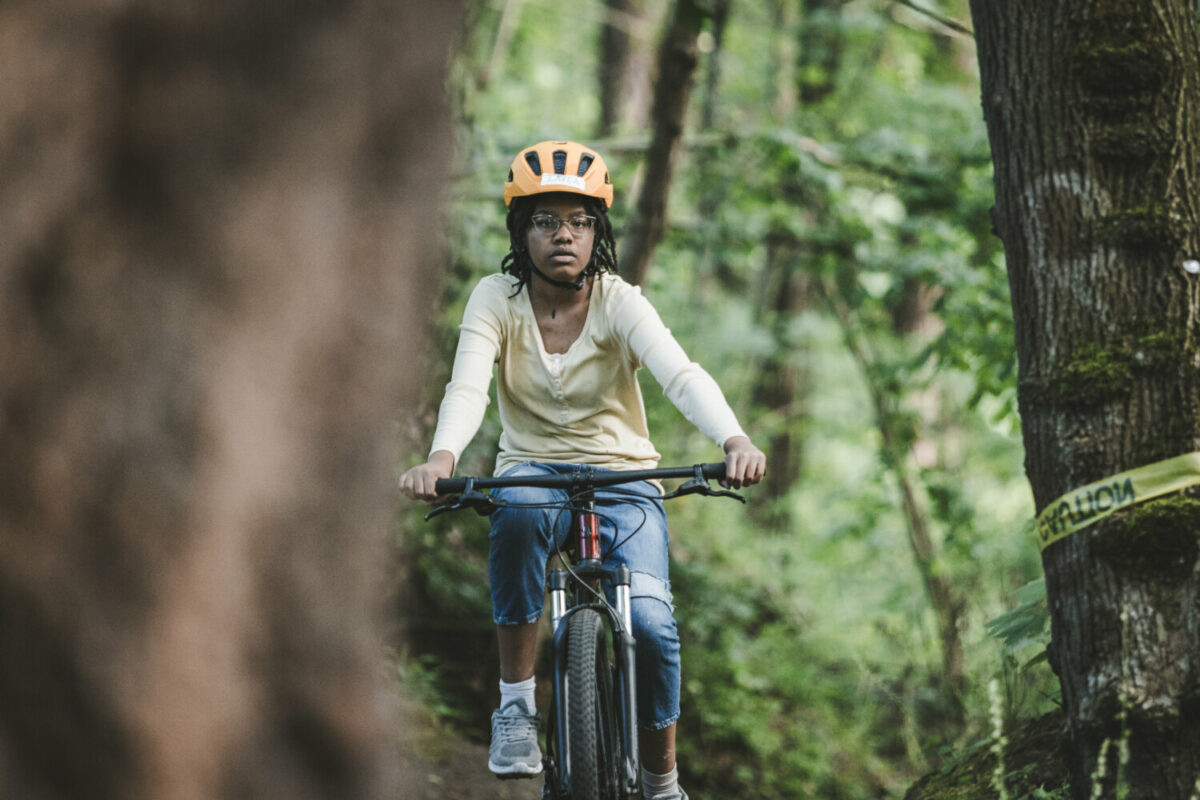 Boys mountain biking instructor leading the way