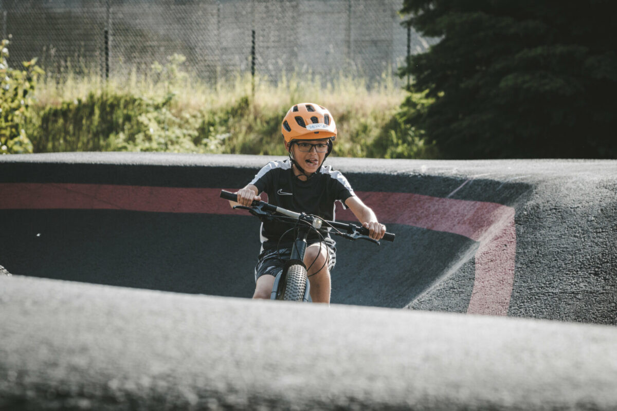 Boys mountain biking with instructors