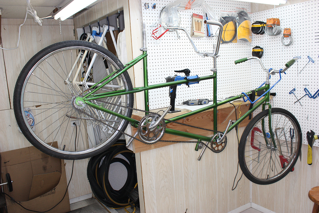 Complete drivetrain of the Schwinn Twinn Tandem, showcasing the restored chains, cranks, and gears.