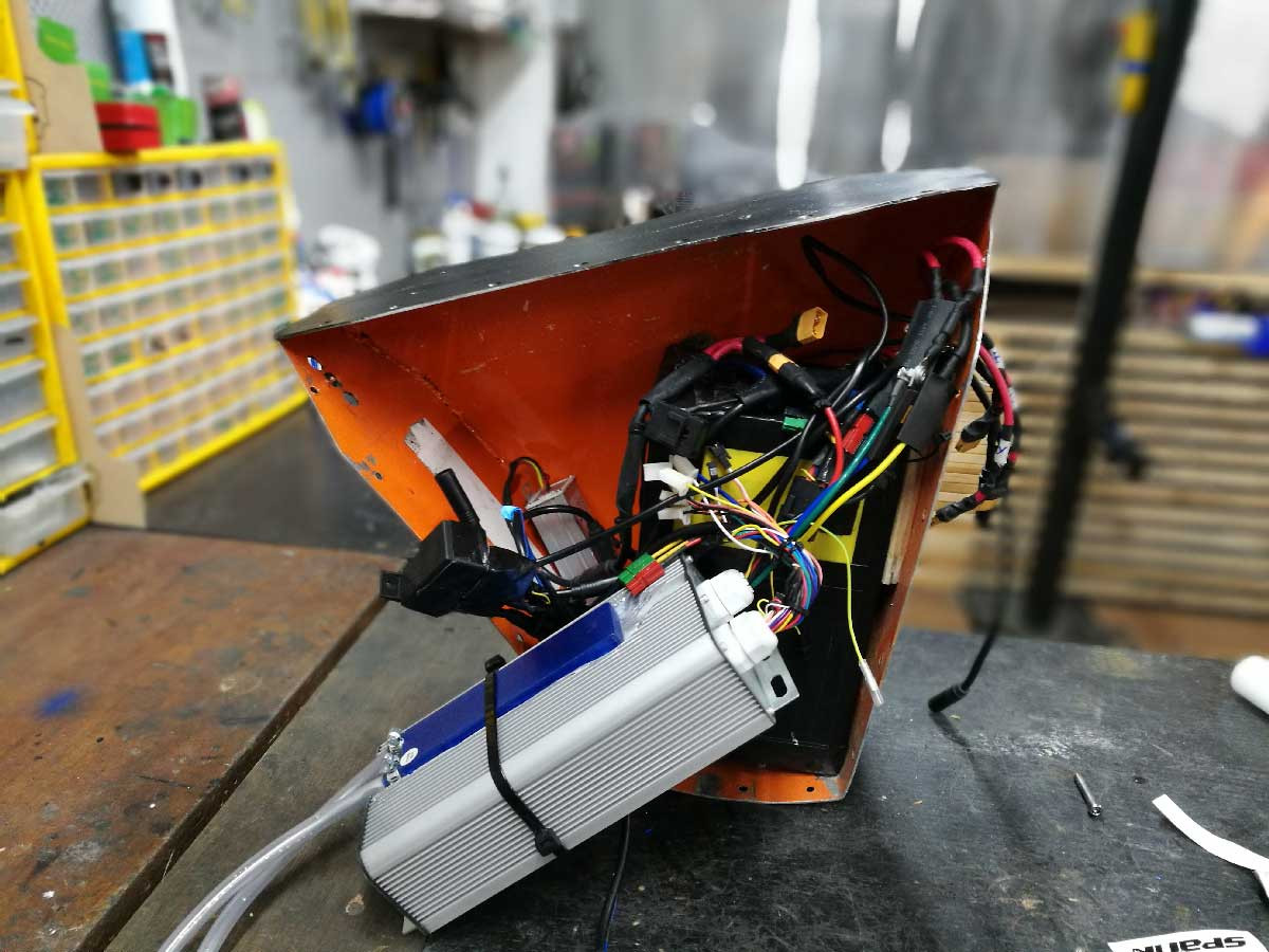 Completed e-bike water-cooled controller setup, showcasing the pump and tubing integrated into the custom build