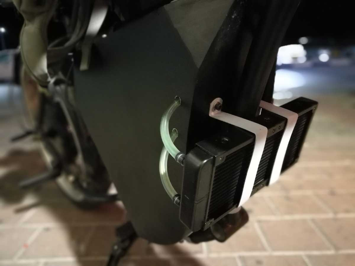 Applying epoxy glue mixed with aluminum shreds to the e-bike controller for improved heat transfer to the water block