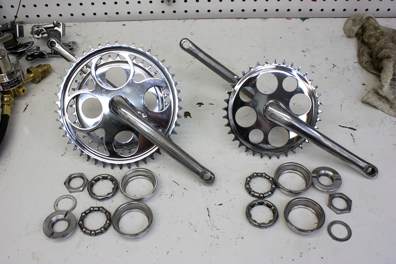 Polished crankset and components of the Schwinn Twinn Tandem after restoration, highlighting the renewed shine.