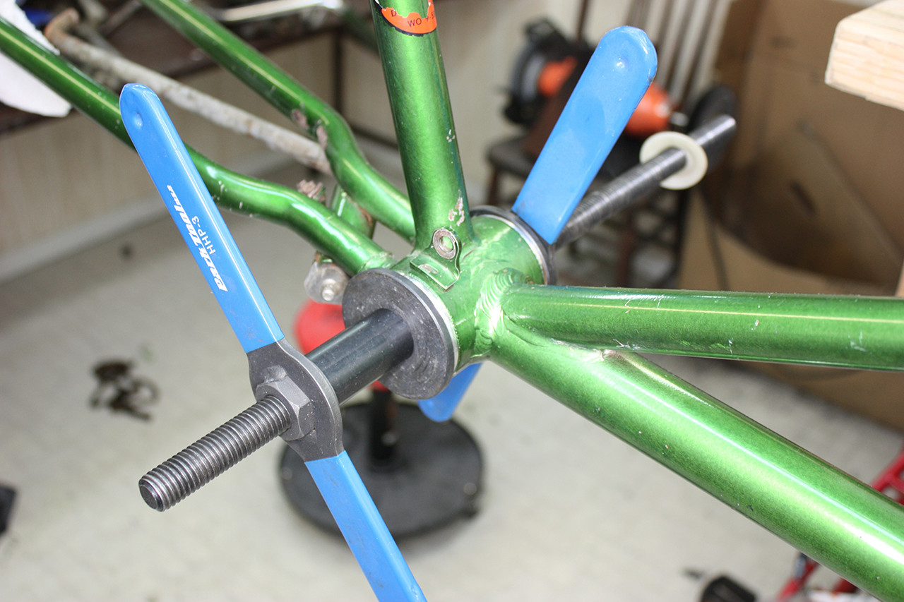 Rear crank cups being pressed into the frame of the Steve Schwinn bike, part of the bottom bracket installation.