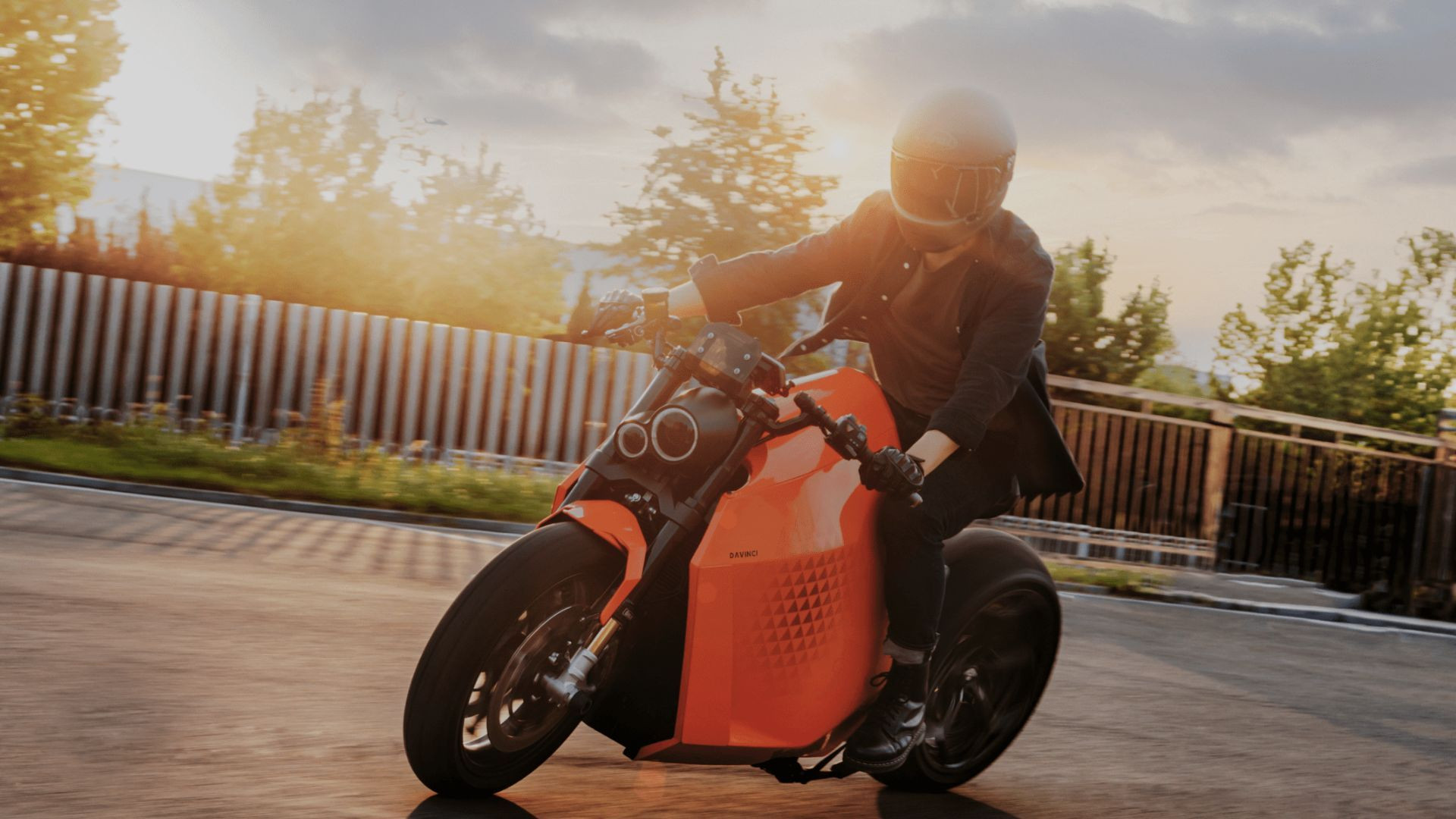 Front three quarter view of an orange Davinci DC100 electric motorbike