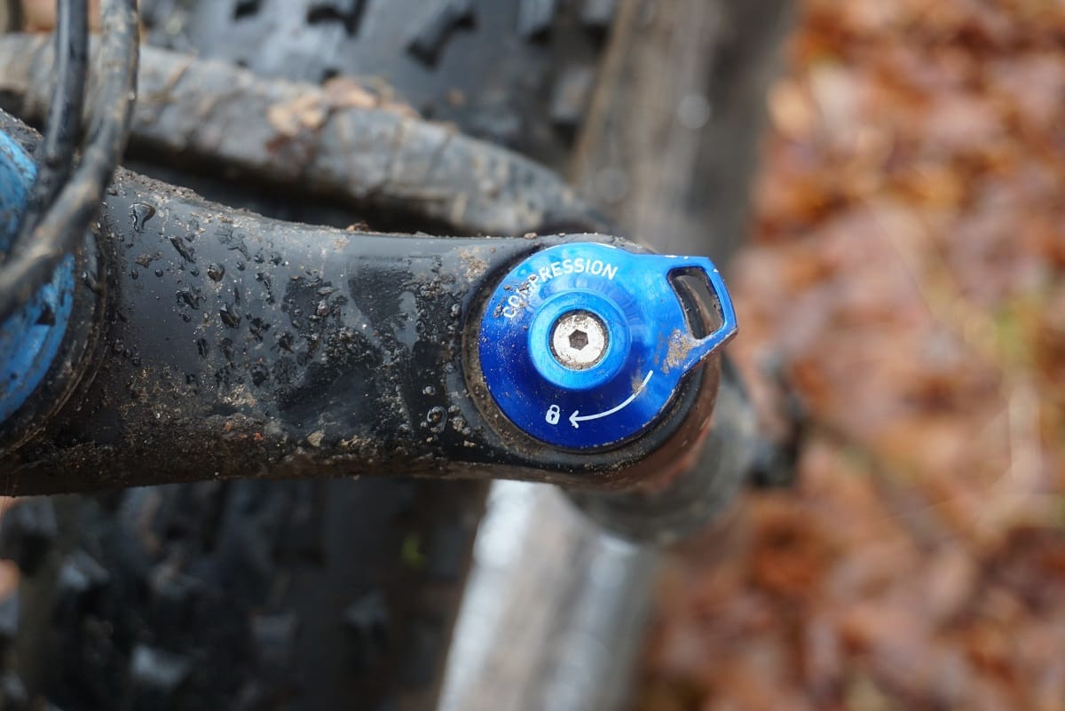 Blue anodized compression dial on RockShox Bluto, showcasing adjustability and design details