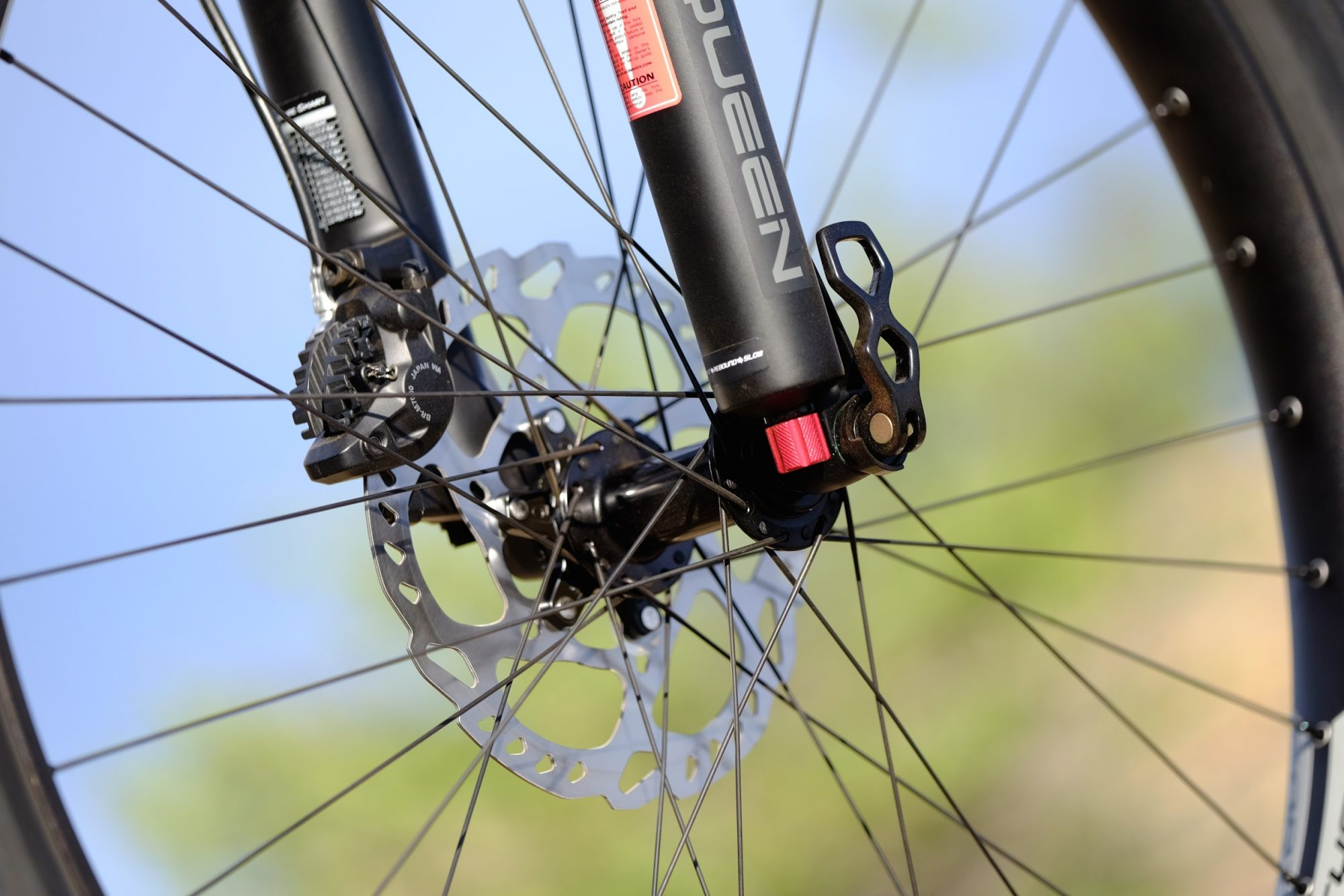 REI Co-op DRT 2.1 traversing a scenic trail, illustrating its versatility and suitability for various terrains.