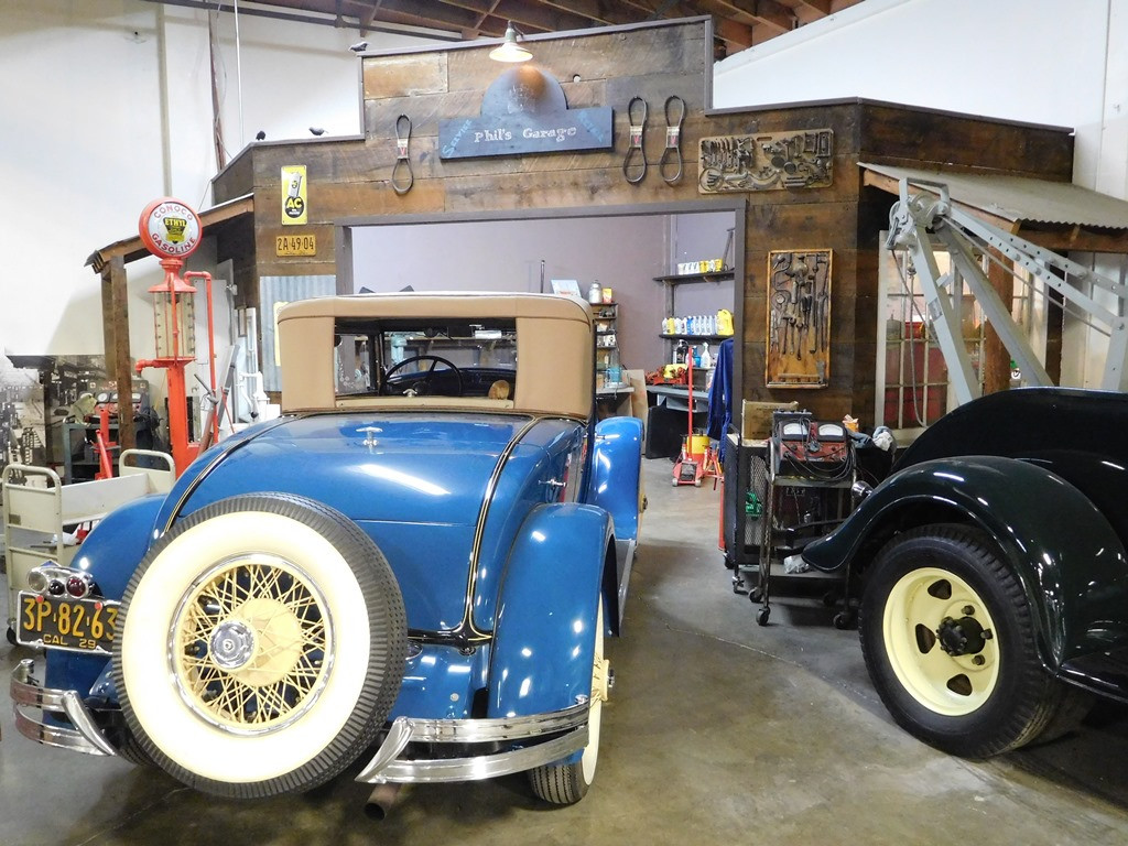 Mechanics at Phil's Garage maintaining vintage museum vehicles