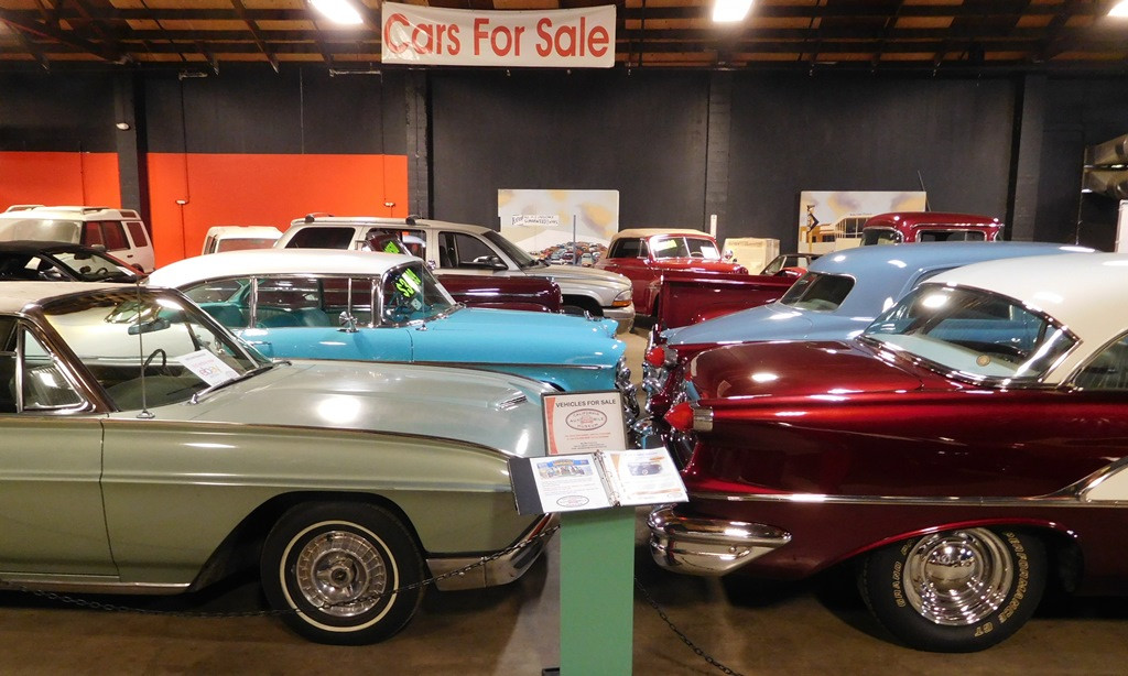 Museum shop with restored vintage cars for sale