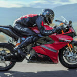 Rider leaning into a turn on a red Energica Ego+ RS electric motorbike