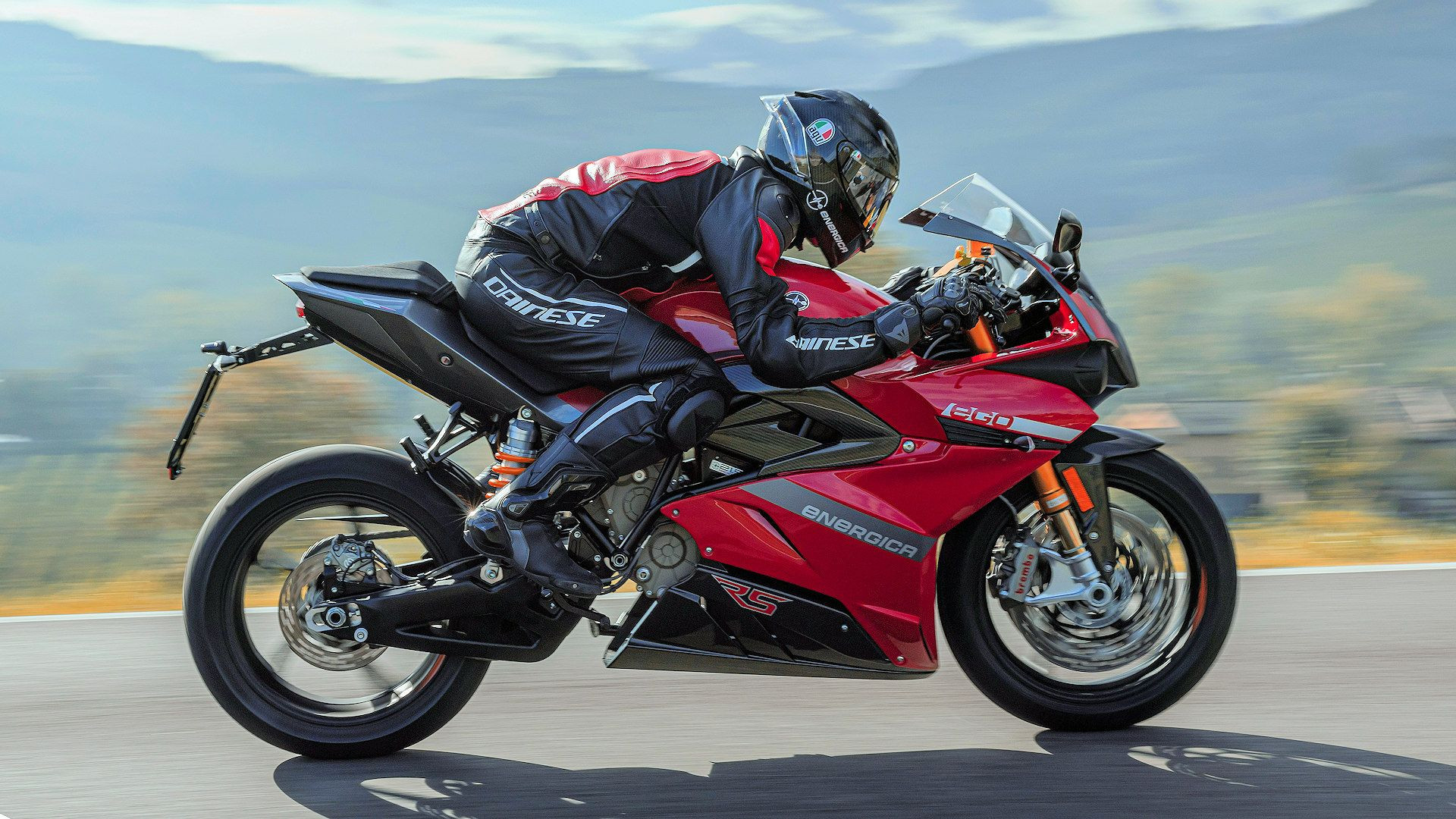 Rider leaning into a turn on a red Energica Ego+ RS electric motorbike