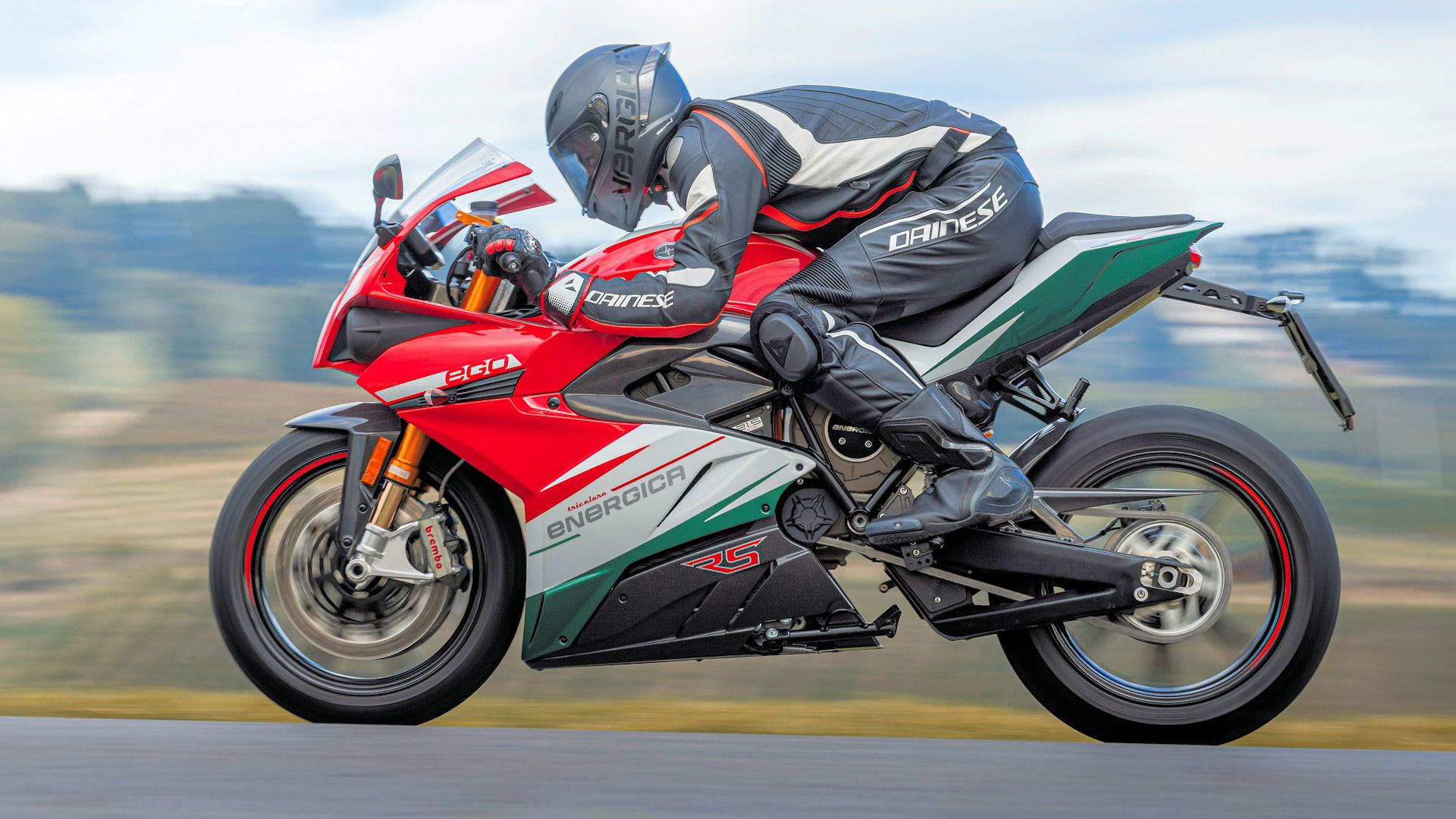 Rider on a 2023 Energica Ego+ RS Tricolore electric motorbike on a track