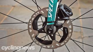 Mountain bike disc brake rotors are prominently displayed at a Tour de France event.