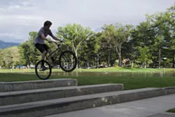 FOAD bike crew members Sam Allgood, Jackson Bradshaw, Parker Thompson, and Izik and Evan Service pose with their fixie bikes at Liberty Park, showcasing urban fixed gear freestyle culture.