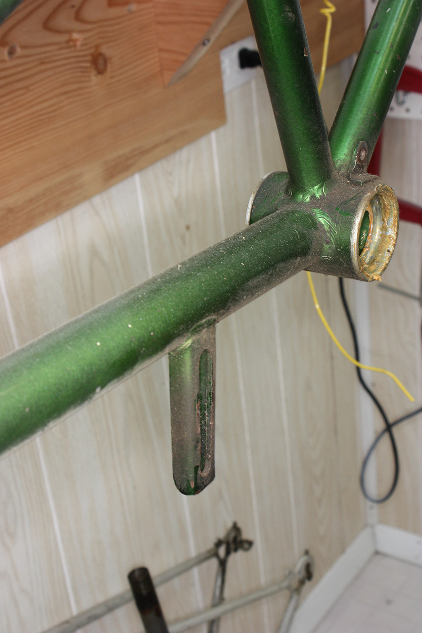 Detailed view of the chain tensioner area on the dirty frame of the vintage Schwinn tandem prior to restoration.