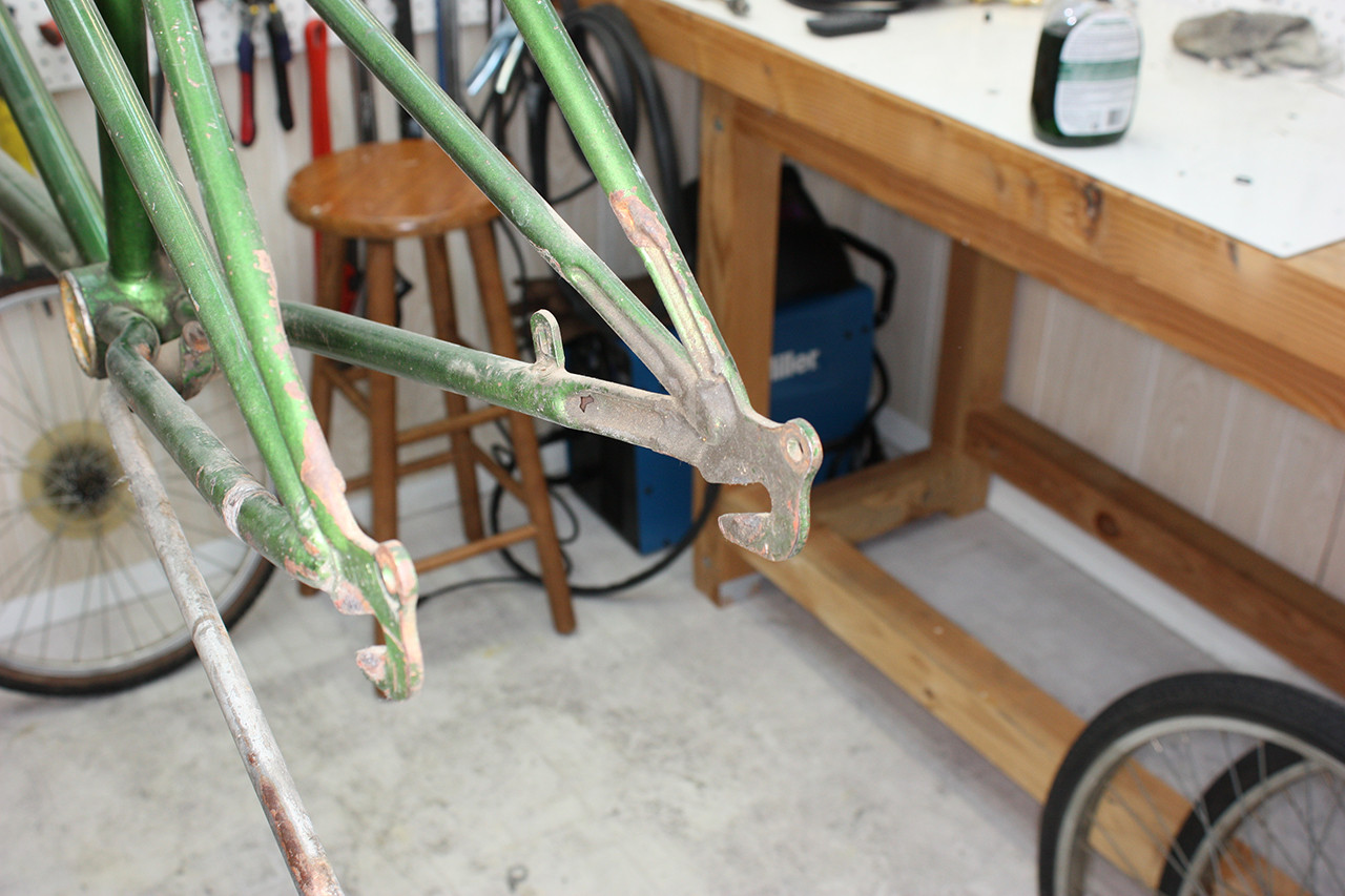 Dropout area of the Schwinn Twinn Tandem frame showing dirt accumulation before the cleaning process.