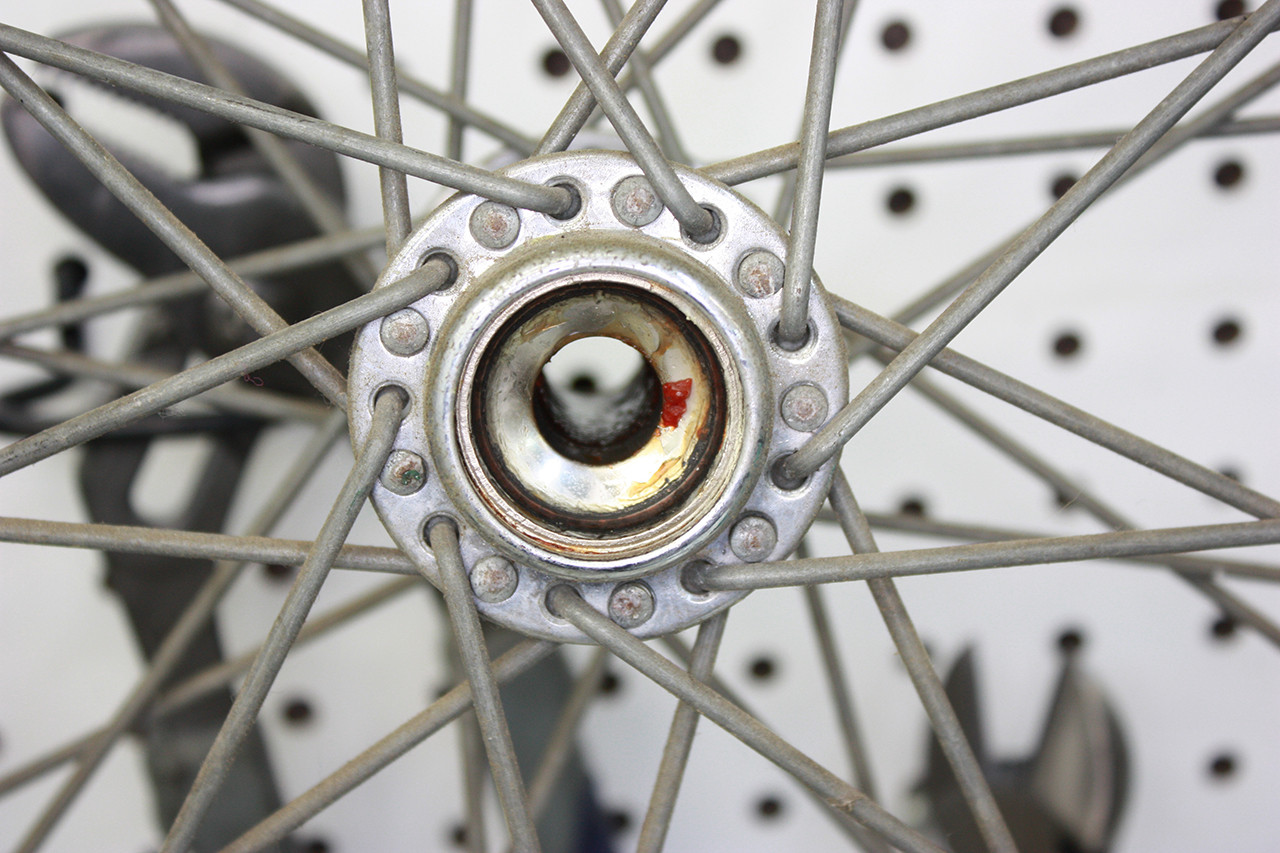 Front wheel bearings of the Steve Schwinn bike before cleaning, showing dried grease and dirt.