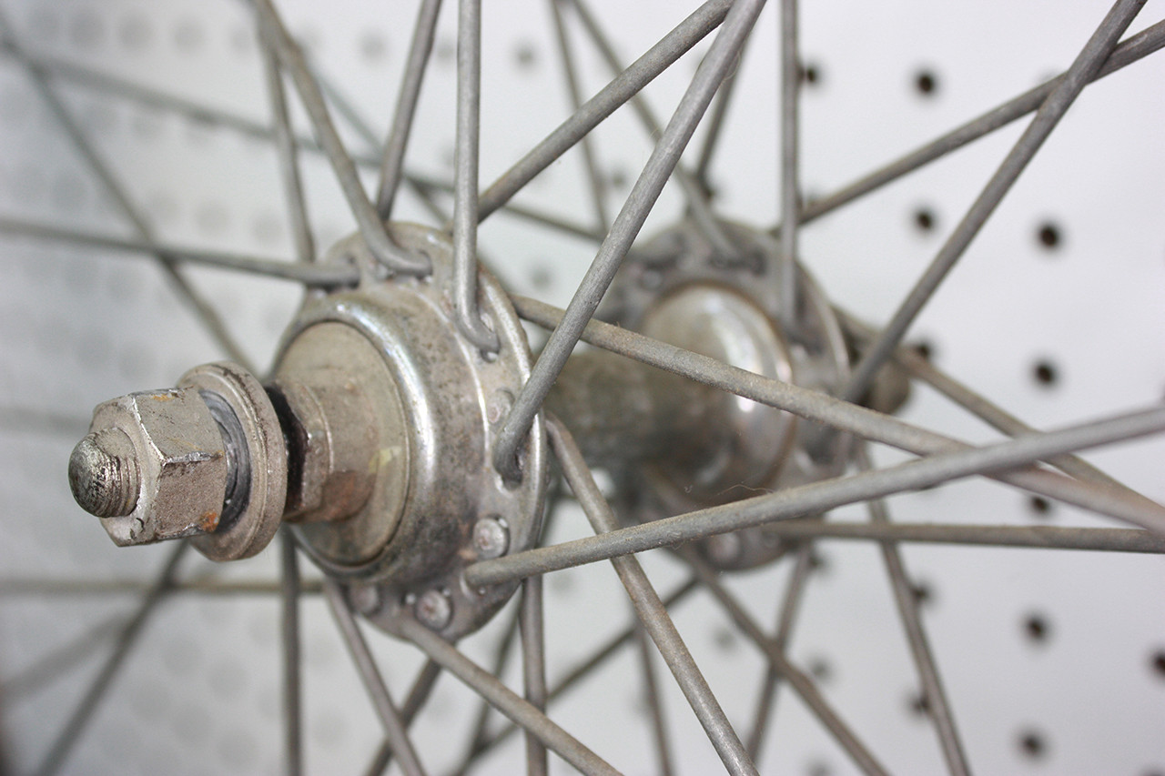 Front wheel hub of the Schwinn Twinn Tandem before cleaning, showing dirt and aged grease.