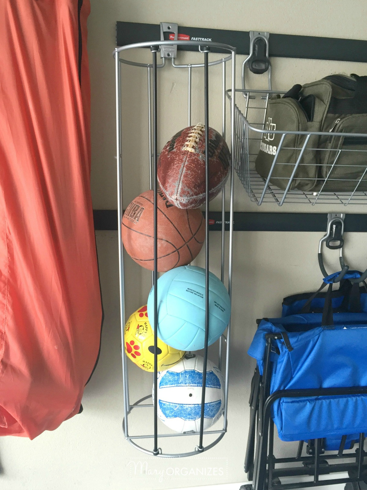 Sports balls organized in a ball organizer in a garage.