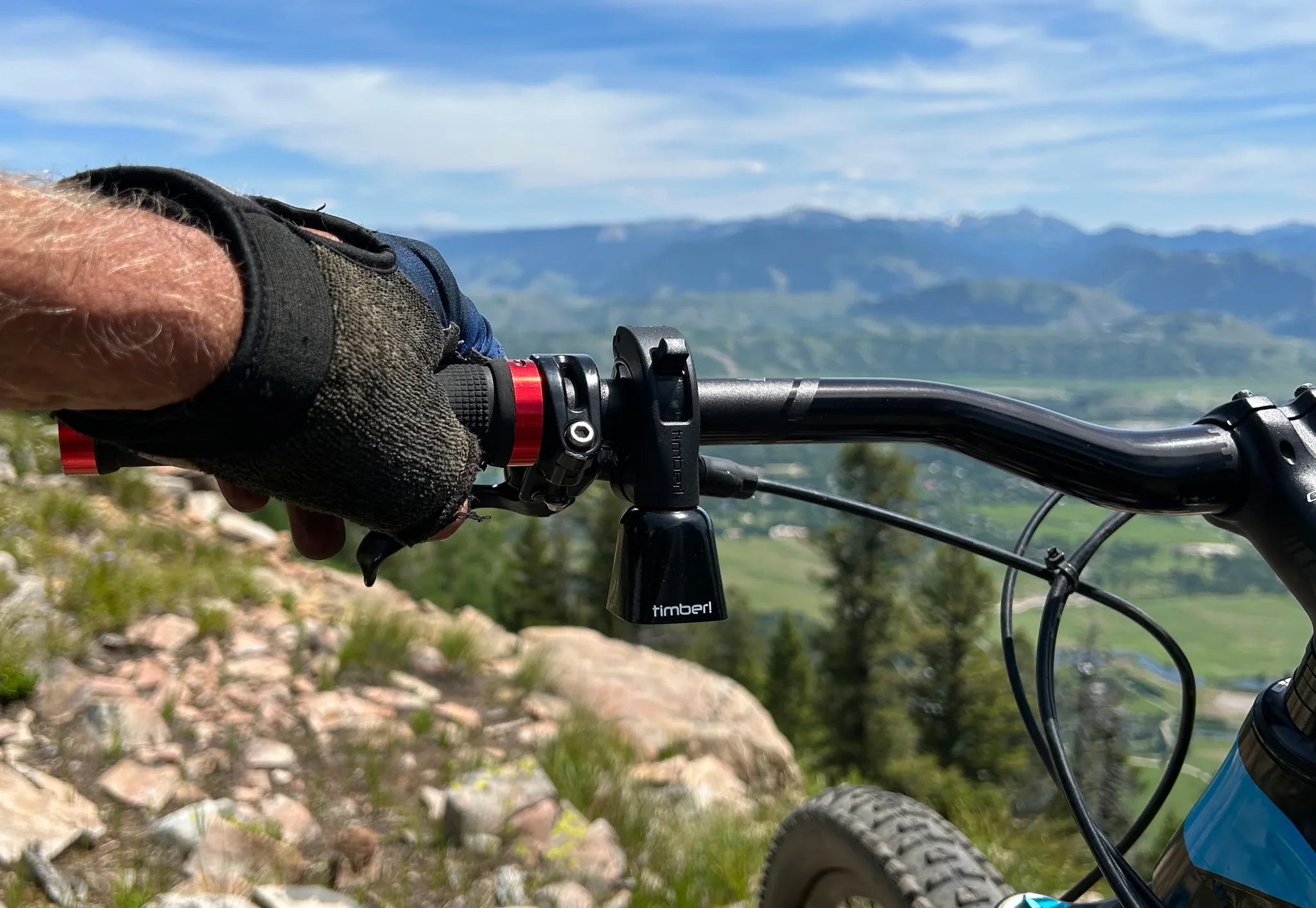 Close-up of Timber Quick Release Mountain Bike Bell on handlebar, ideal bike gift for mountain bikers