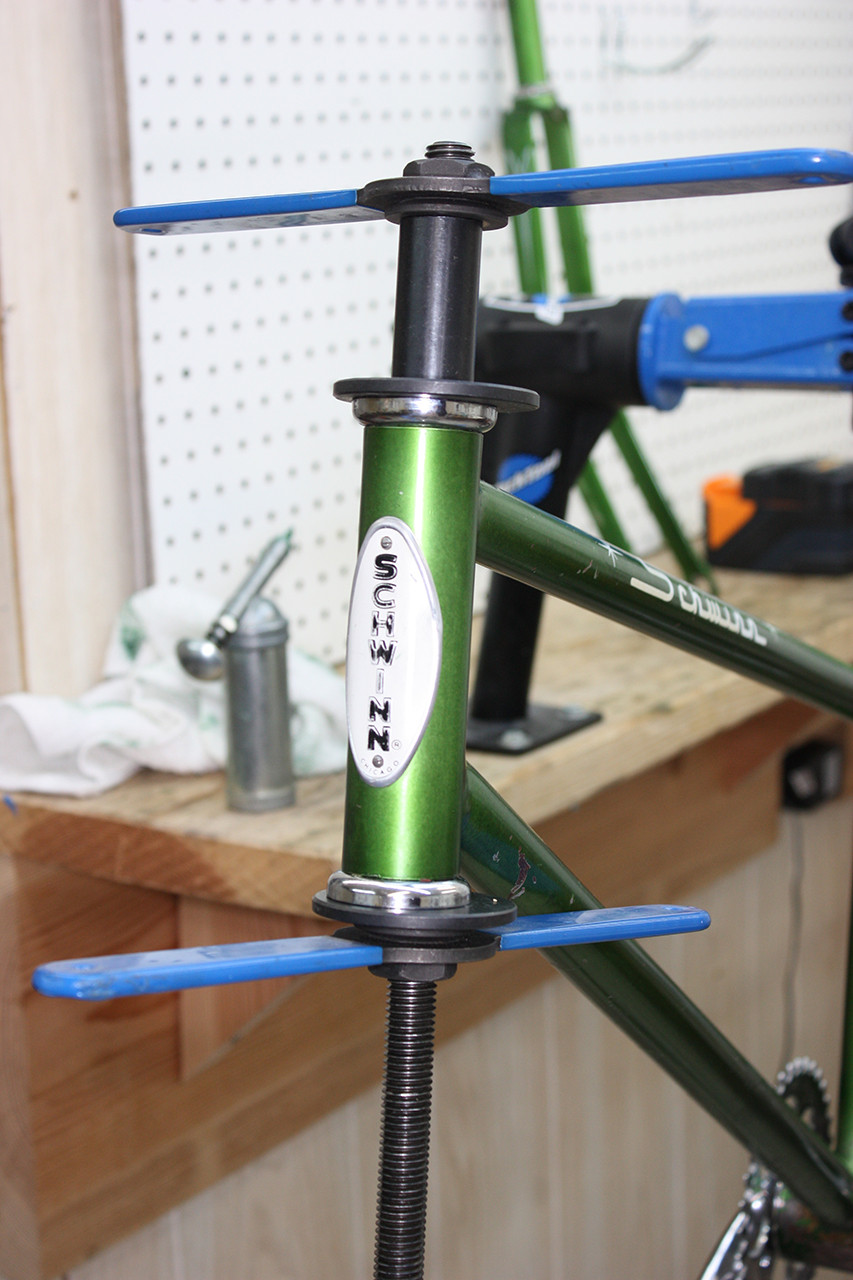 Headset cups being pressed into the frame of the vintage Schwinn tandem, ensuring proper fitment and alignment.