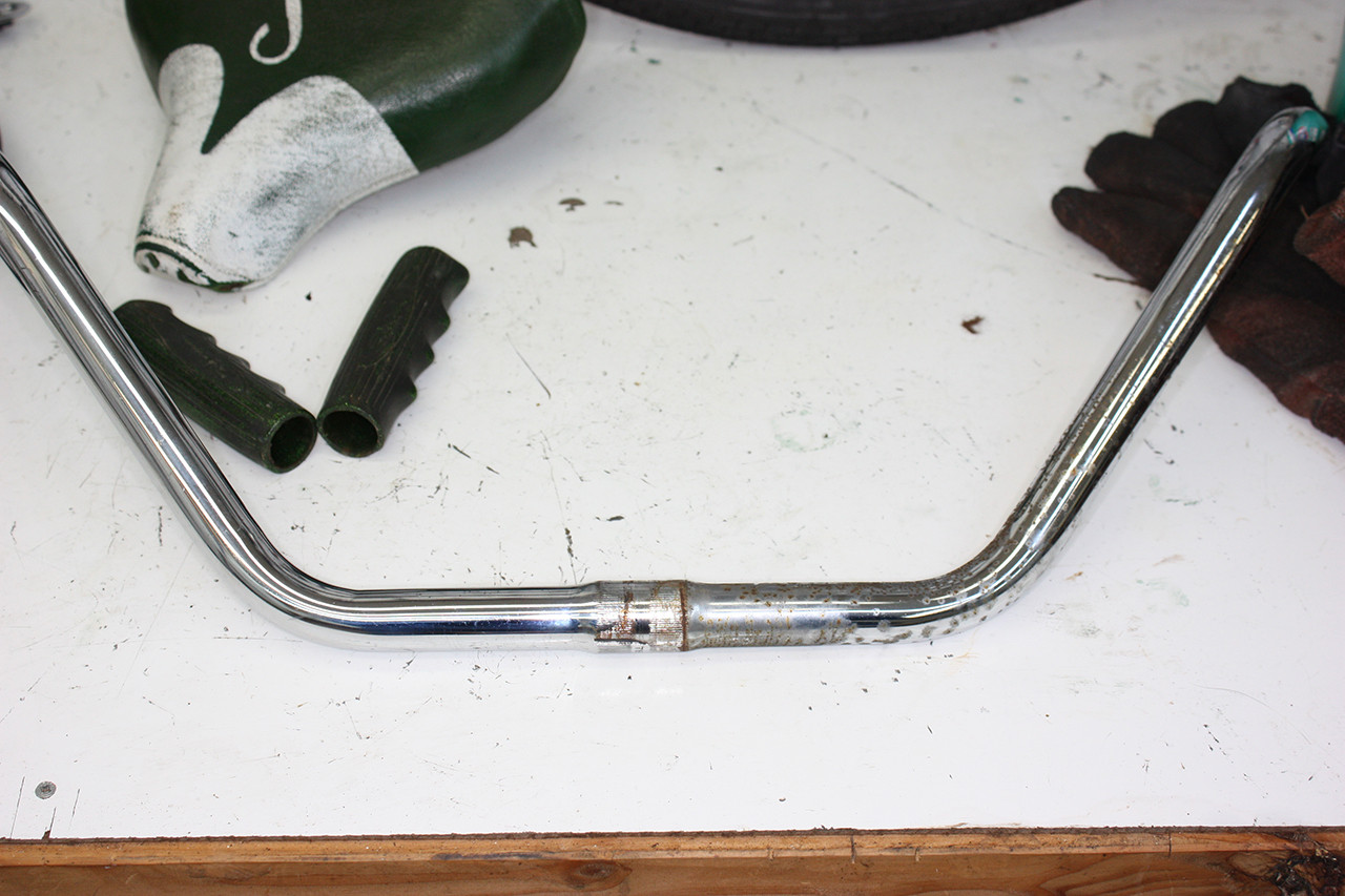 Rear handlebars of the Steve Schwinn bike partially polished, showing the contrast between before and after.