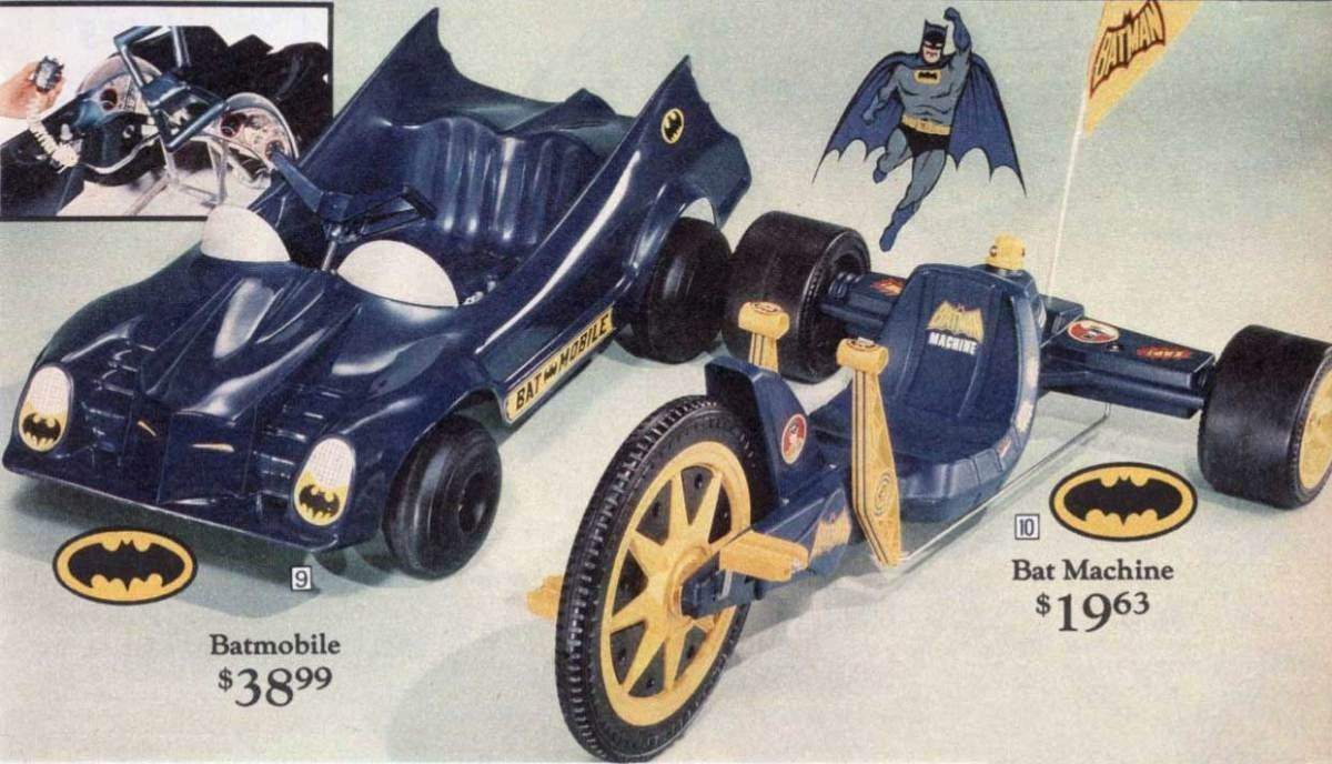 A close-up image of a vintage Batman Machine, highlighting the Batman-themed stickers and overall design.